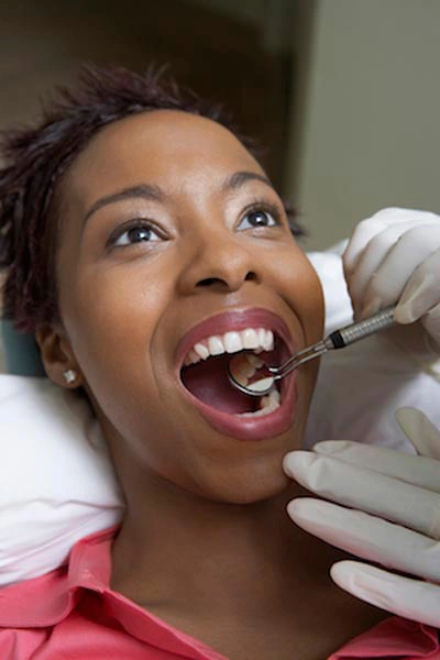 patient receiving a checkup after a cosmetic dentistry procedure at Barrera Advanced Dentistry in Torrance, CA