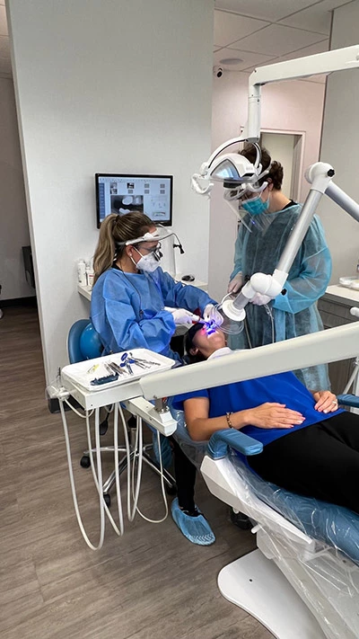 Barrera Advanced Dentistry staff placing dental crown for patient