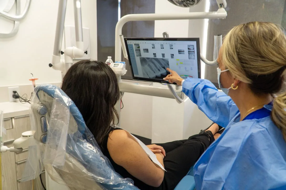 Dentist at Barrera Advanced Dentistry showing patient their x-ray on a screen